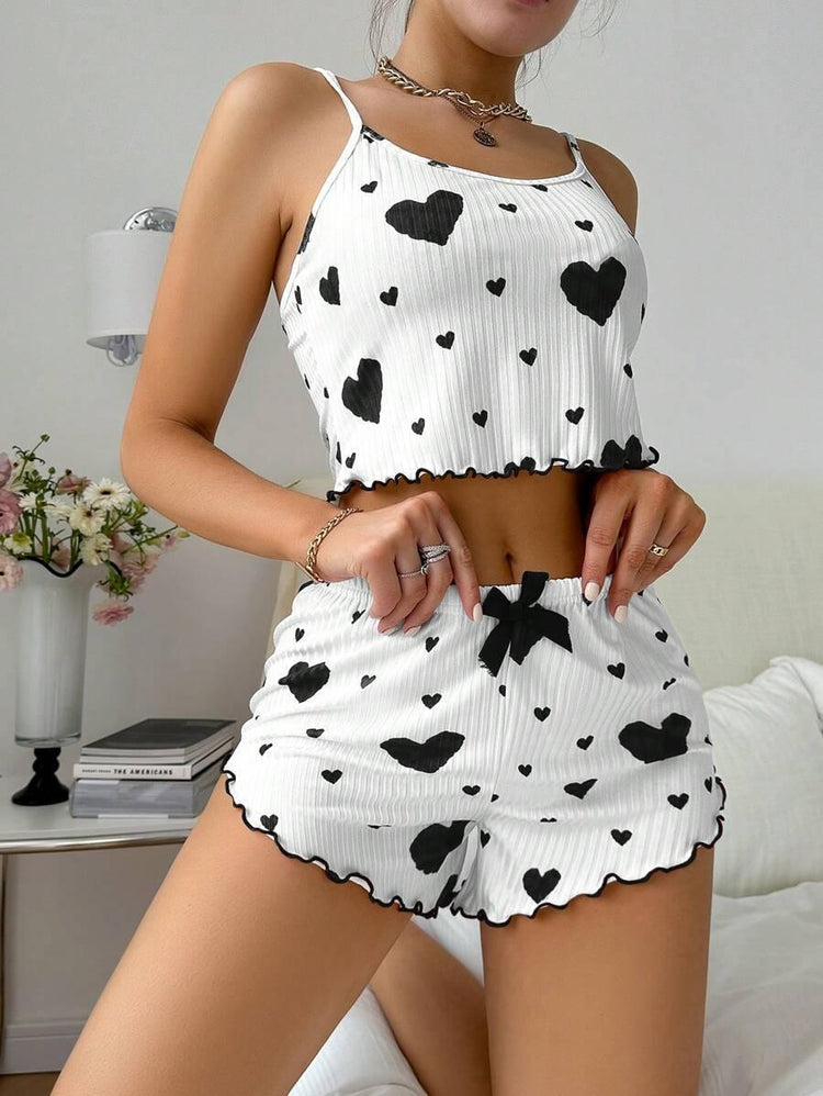 White ribbed pajama set with black heart print, spaghetti straps, relaxed fit, ruffled hems