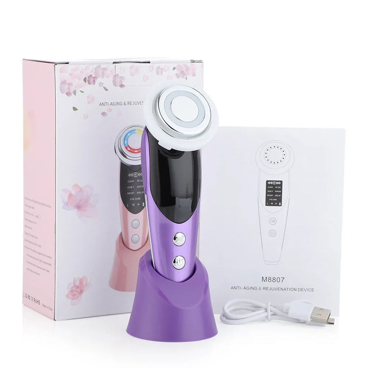 Purple handheld skincare device with metallic head, USB cable, and packaging on white background.