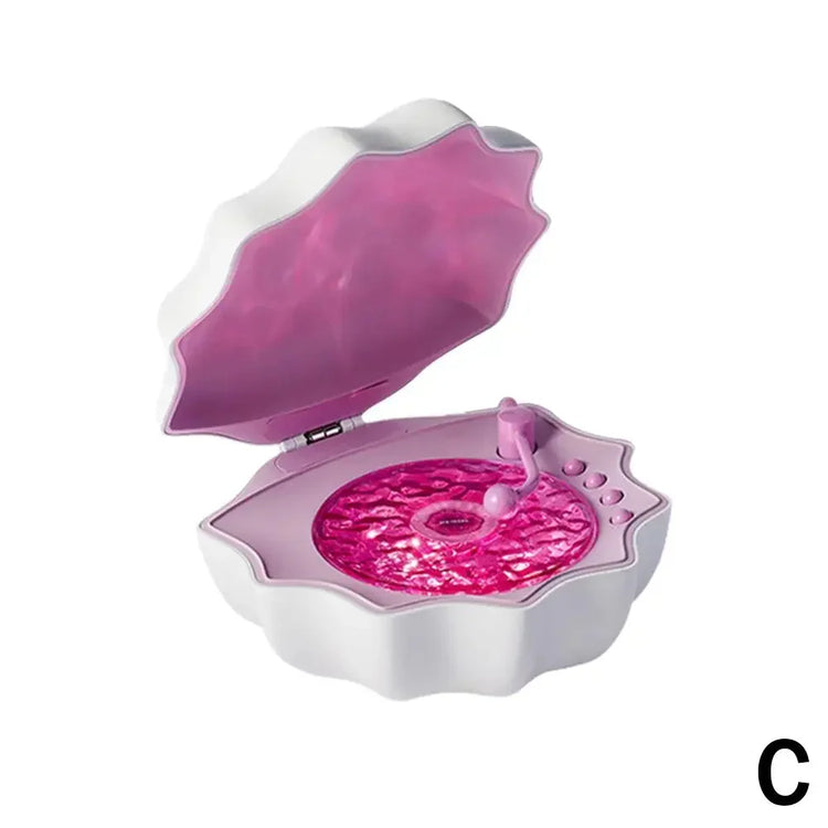 White and pink clam-shaped jewelry box with textured interior and buttons, modern design