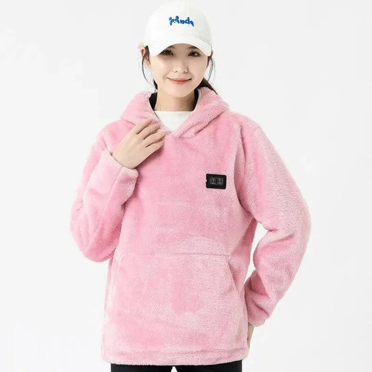 Woman wearing a loose fit pink fleece hoodie with long sleeves and front pocket, cozy streetwear style.