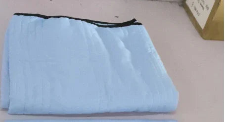 Folded light blue streetwear garment with black trim, soft fabric, relaxed fit