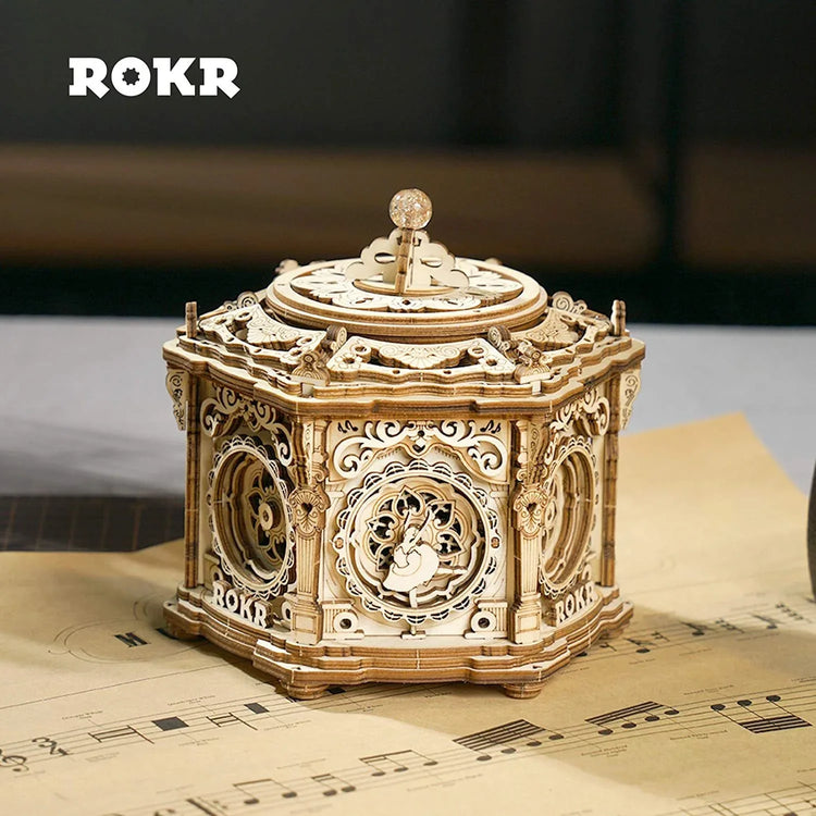 Intricately detailed wooden music box with ornate laser-cut design on tabletop
