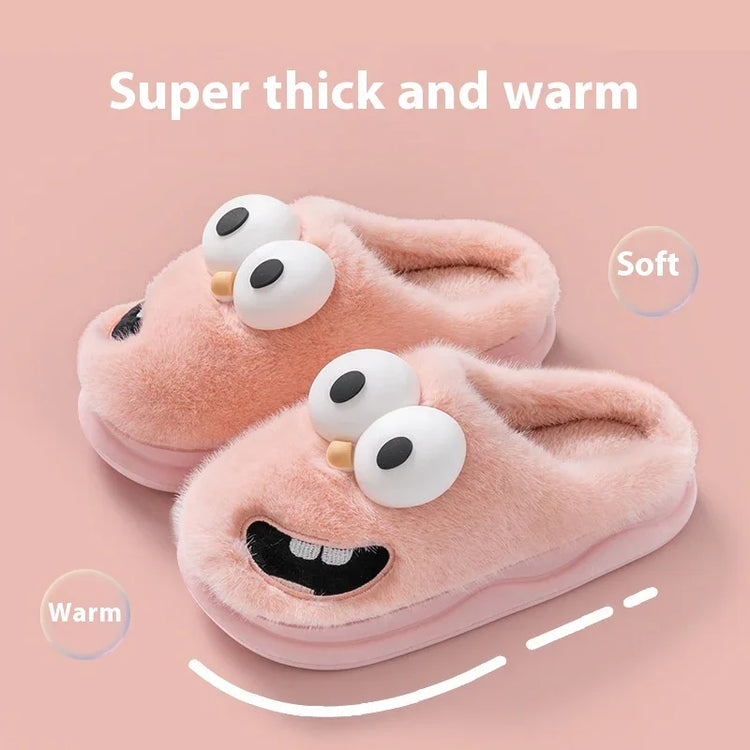 Plush pink fuzzy slippers with cartoon eyes and smiling face, thick warm cozy fit.
