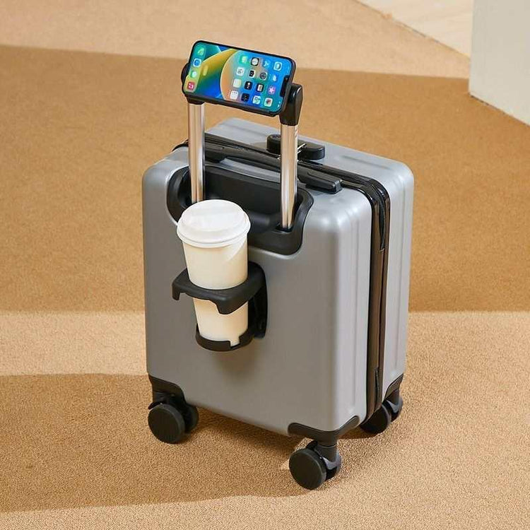 Silver hard-shell suitcase with tech accessory holder for smartphone and beverage cup, modern design