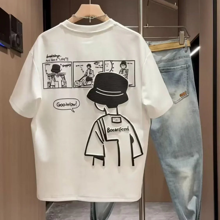 White oversized streetwear t-shirt with black comic print, paired with light wash denim jeans.