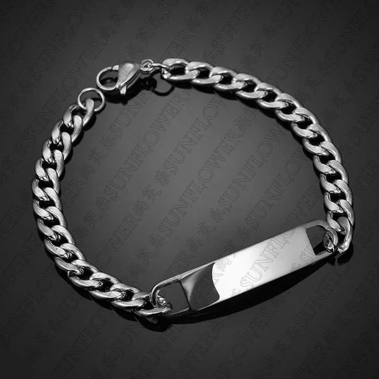 Silver chain bracelet with curb links and polished ID plate, sleek streetwear accessory