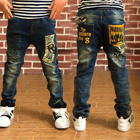 Children wearing blue denim jeans with bold graphic patches, slim fit streetwear style