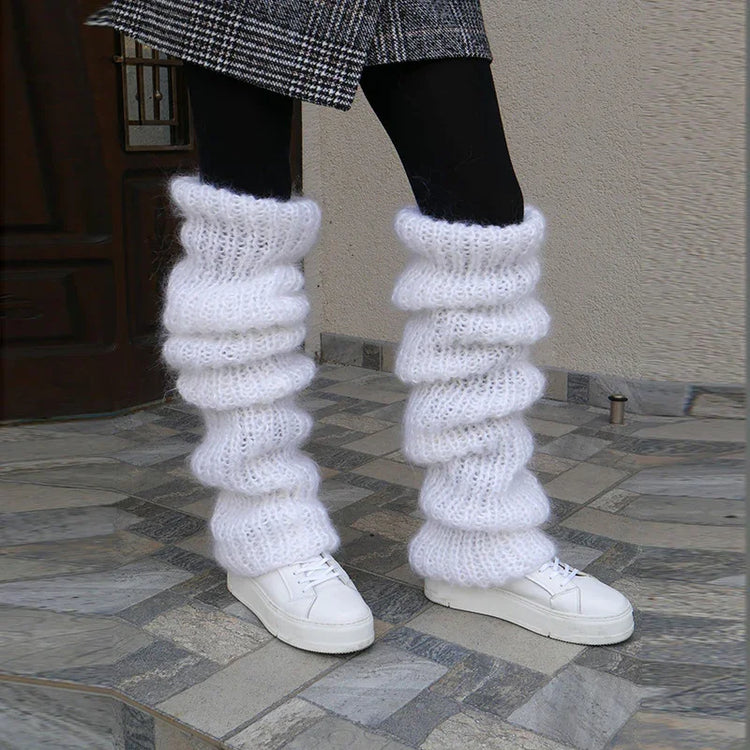 Chunky white knit leg warmers, textured wool, loose fit, styled with white sneakers and black tights