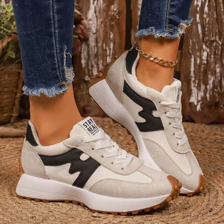 White and beige chunky sneakers with black accents, suede panels, lace-up style, and gum soles