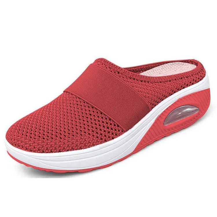 Red slip-on mesh sneaker with thick white sole and breathable fabric design
