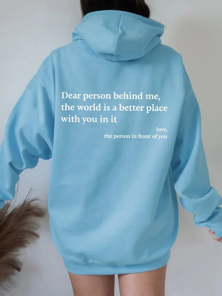 Light blue oversized hoodie with white inspirational text, casual streetwear style, soft fabric