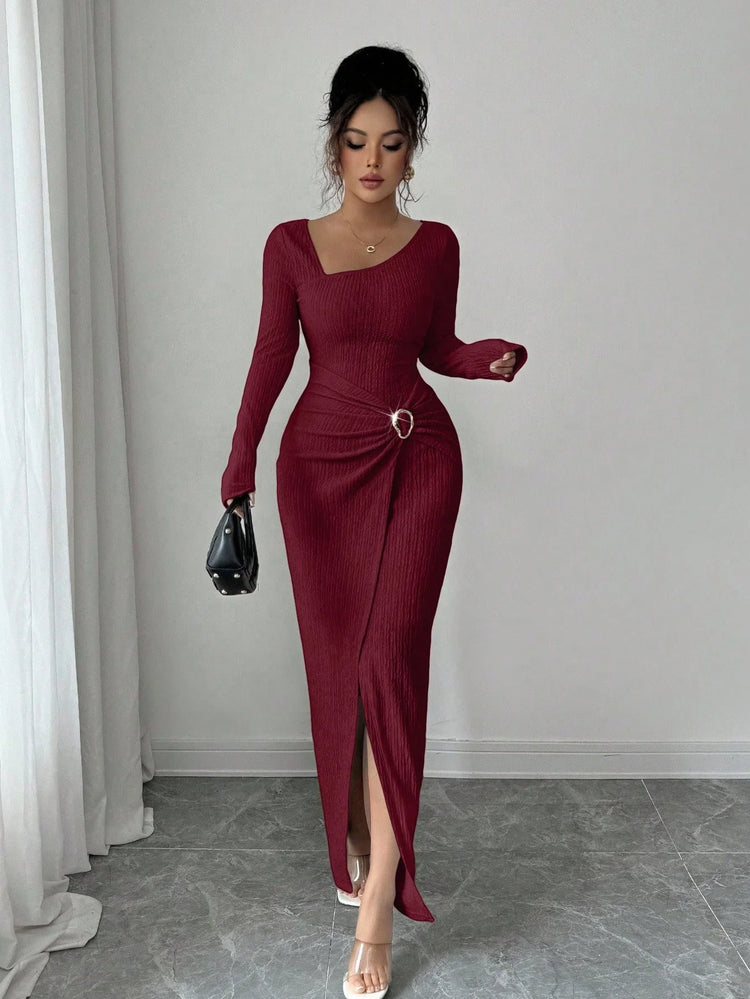 Woman wearing a fitted maroon long-sleeve ribbed dress with side slit and asymmetrical neckline
