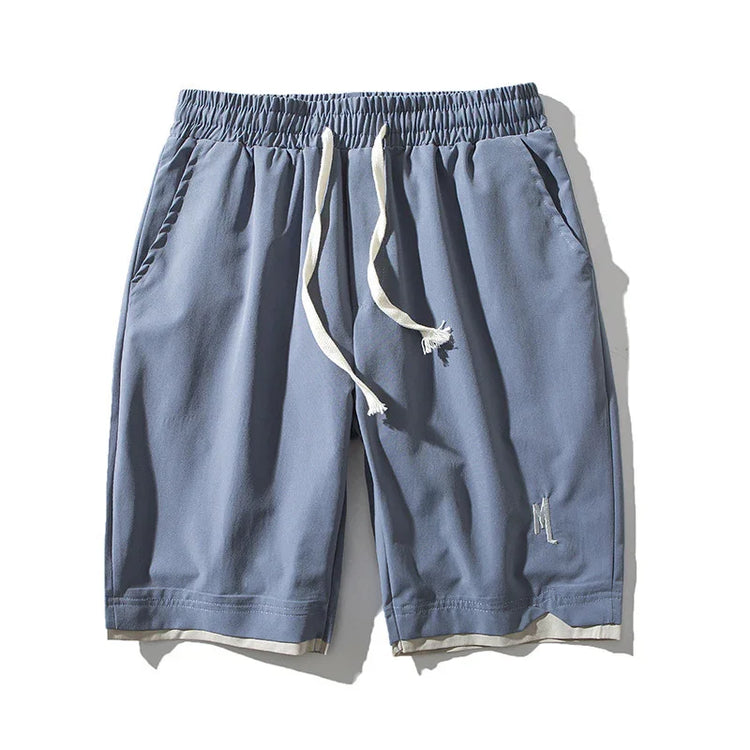 Light blue relaxed fit shorts with elastic waistband, white drawstrings, and side pockets