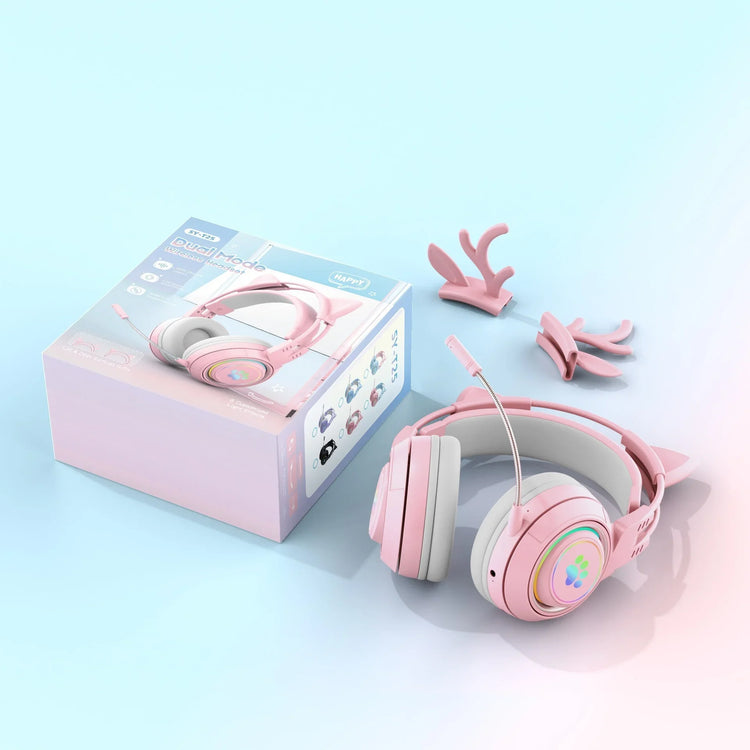 Pink over-ear headphones with cat ear attachments, plush padding, and a detachable microphone on a pastel blue surface.