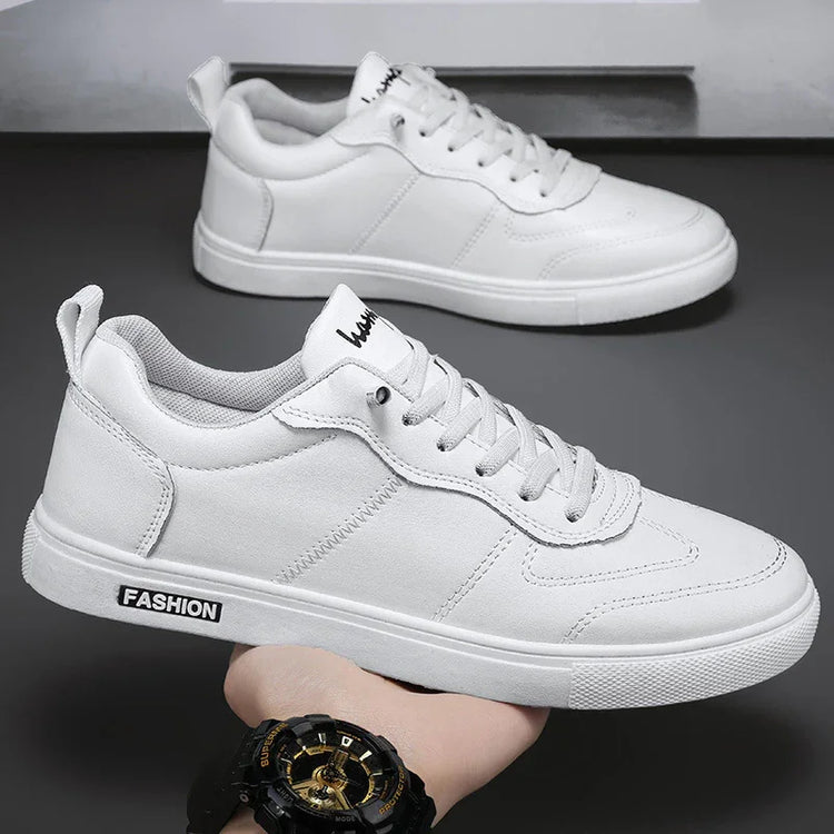 White low-top sneakers with lace-up closure, minimalist design, and casual streetwear style