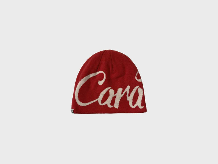 Red knit beanie hat with bold white script graphic, soft material, modern streetwear style