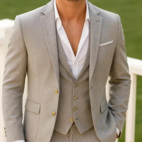 Light grey tailored suit with notch lapels, single-breasted vest, and white dress shirt
