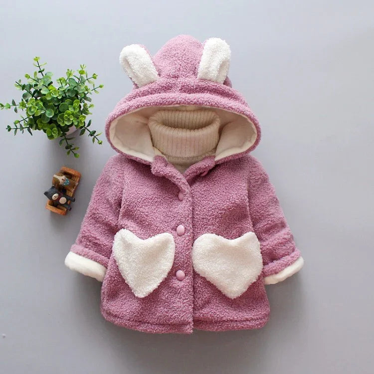 Pink sherpa fleece toddler jacket with heart pockets and bunny ear hood, cozy loose fit.