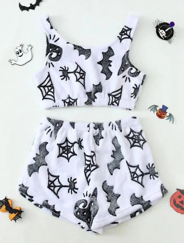 White fuzzy crop top and shorts set with black bat, spider web, and witch hat prints, Halloween theme.