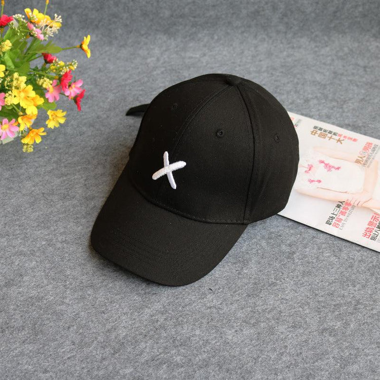 Black cotton baseball cap with white X embroidery, adjustable fit, streetwear style
