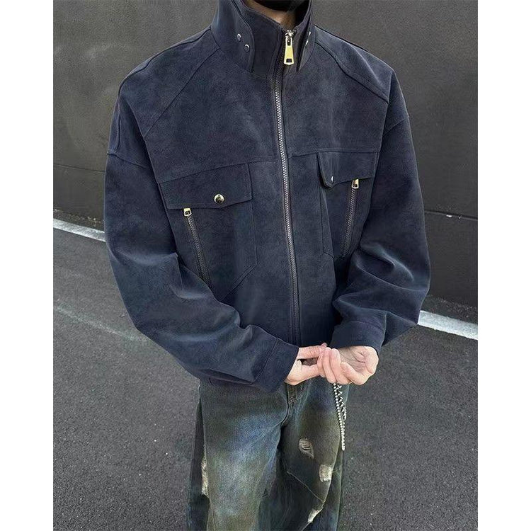 Man in an oversized black suede zip-up jacket with flap pockets and distressed jeans