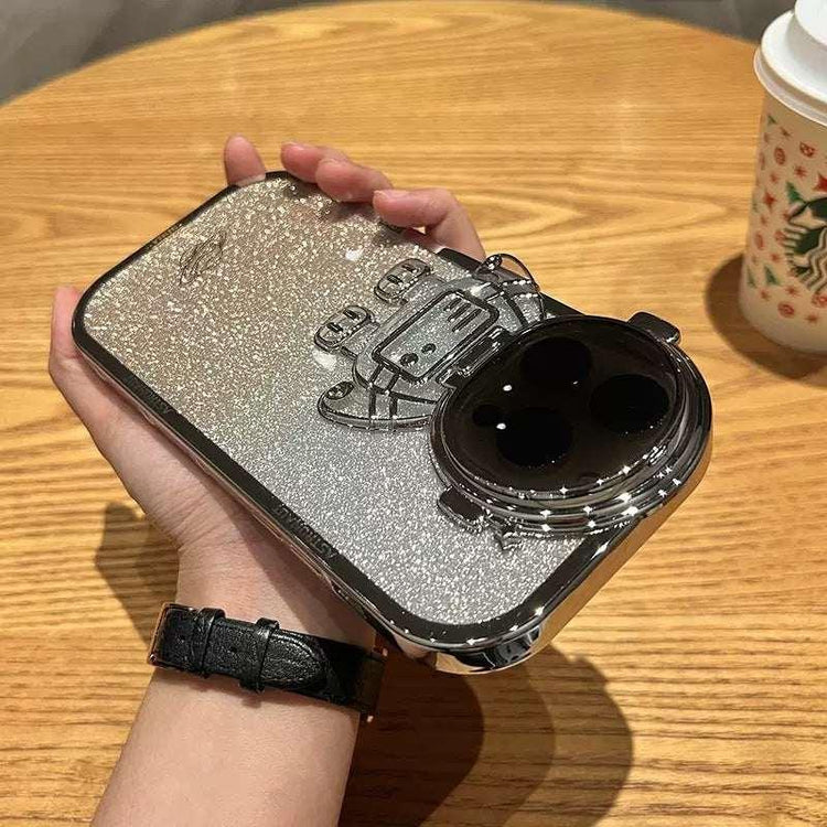 Silver glitter robot-themed phone case with metallic accents, held in hand