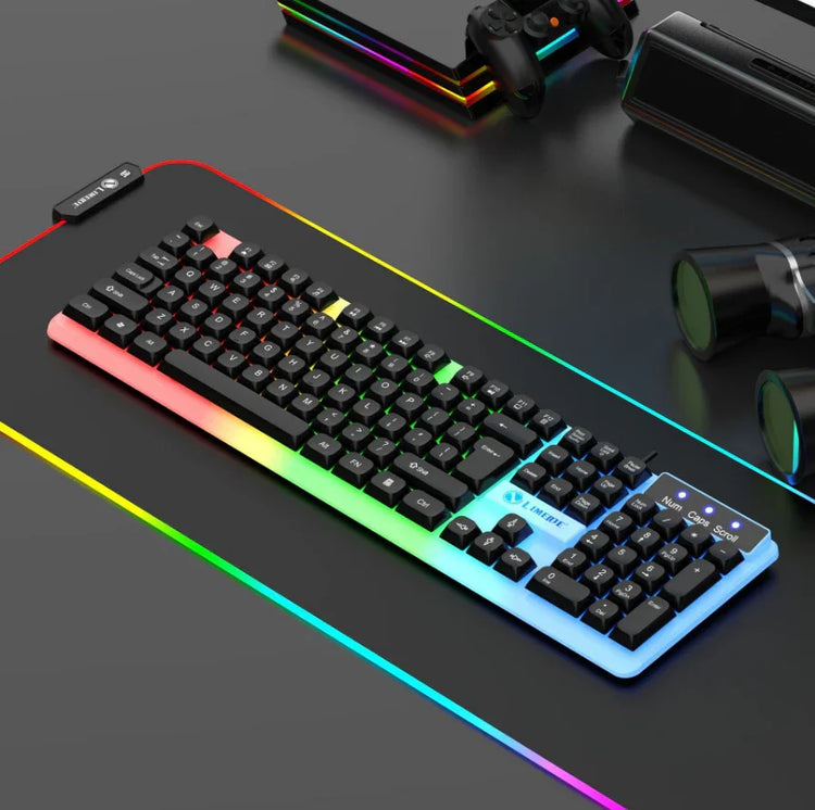 RGB backlit mechanical keyboard on a black desk with gaming accessories