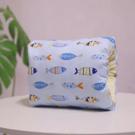 Light blue pillow with playful multicolor fish print, soft fabric, cozy relaxed fit