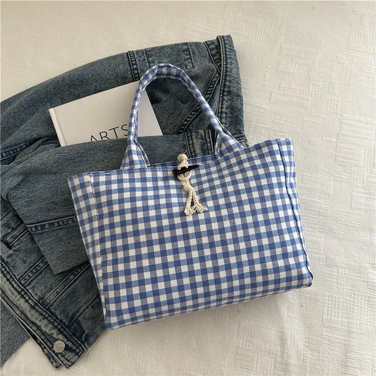 Blue and white gingham tote bag with rope detail, casual fit, cotton material, on denim jacket