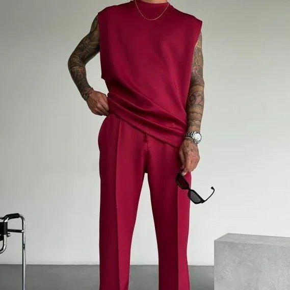 Man wearing sleeveless red oversized top and matching wide-leg trousers, modern streetwear style