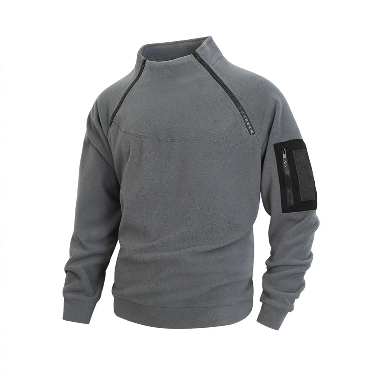 Gray fleece pullover with high collar, black zipper details, and zippered arm pocket, relaxed fit