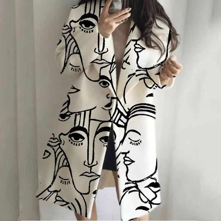 Oversized cream coat with abstract black face print, long sleeves, loose fit streetwear style