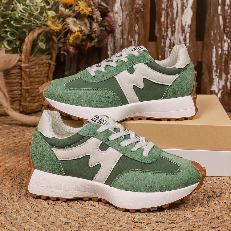 Green suede and mesh sneakers with white accents, chunky sole, casual streetwear style