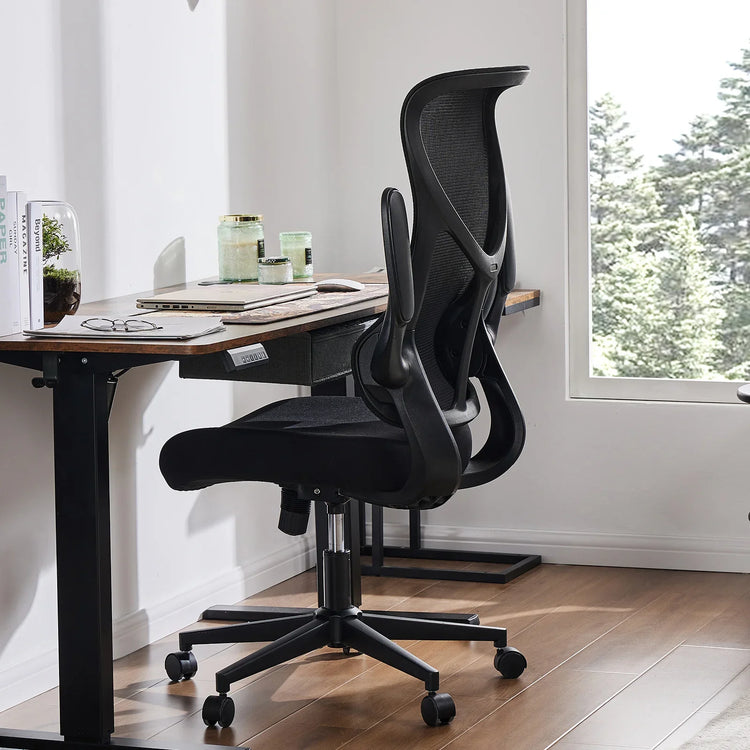 Modern black ergonomic mesh office chair with adjustable features in a minimal home workspace