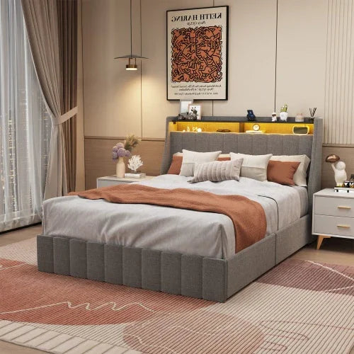Modern bedroom with a gray upholstered platform bed, taupe and rust bedding, and soft neutral decor.