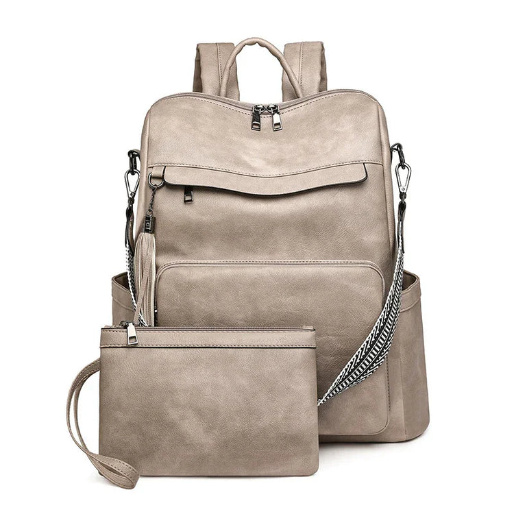 Beige faux leather backpack and matching pouch with silver zippers, modern minimalist style.