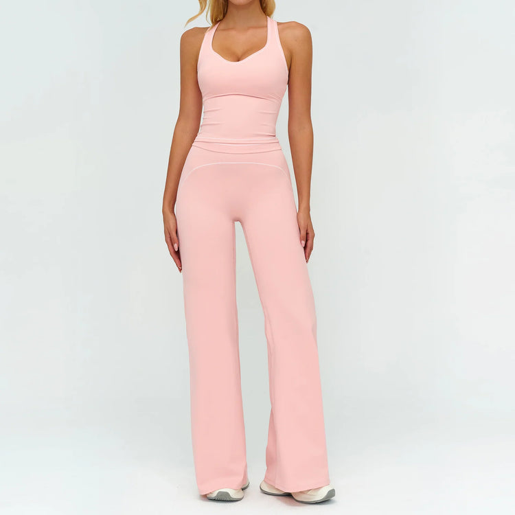 Woman wearing light pink fitted tank top and wide-leg pants, stretchy activewear set