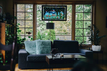 Cozy dark gray sofa with plush light blue throw pillows in sunlit living room