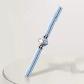 Minimalist light blue double-ended tech accessory with metallic accents on white surface