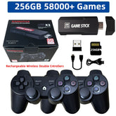 Black wireless gaming console with two controllers, USB stick, SD card, and charging cable.