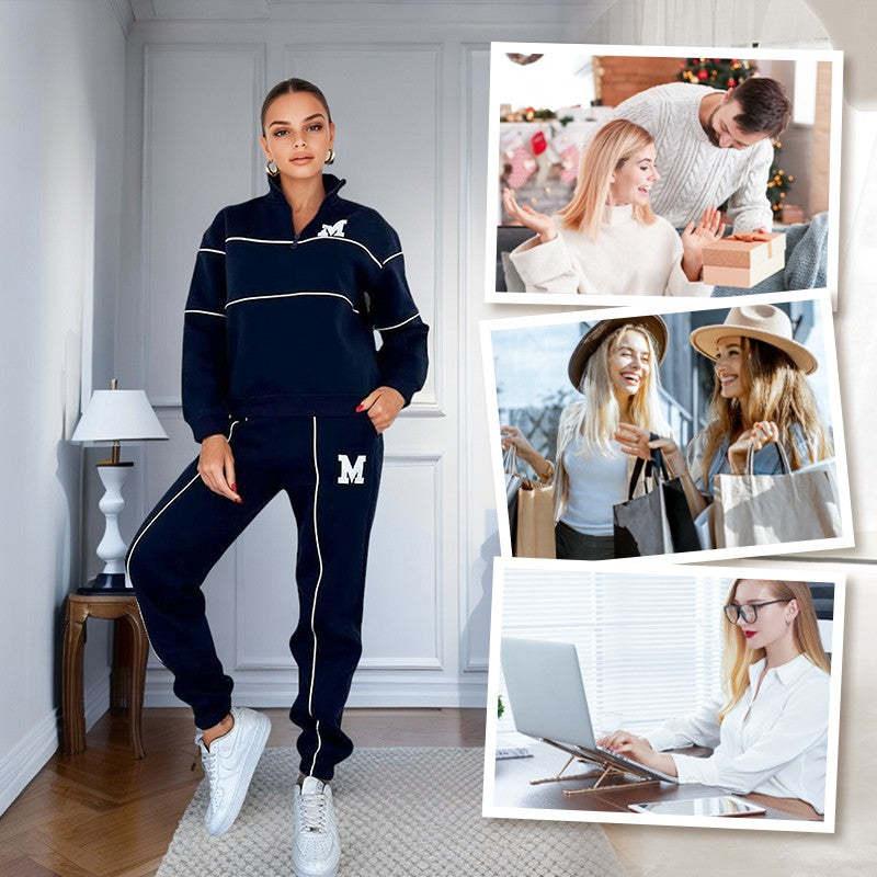 Woman wearing navy blue tracksuit with white piping and &