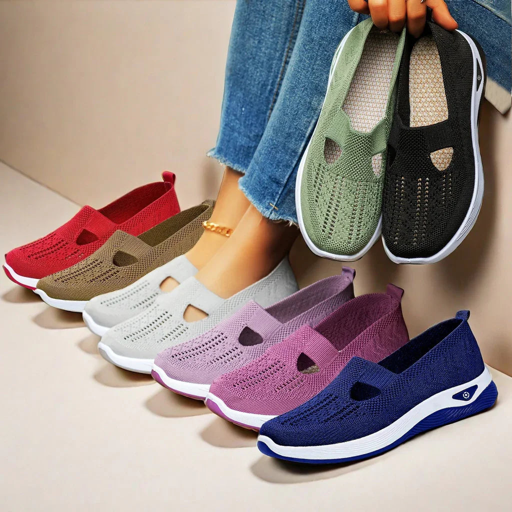 Assorted breathable knit slip-on shoes in various colors, casual fit, white soles, displayed with jeans.