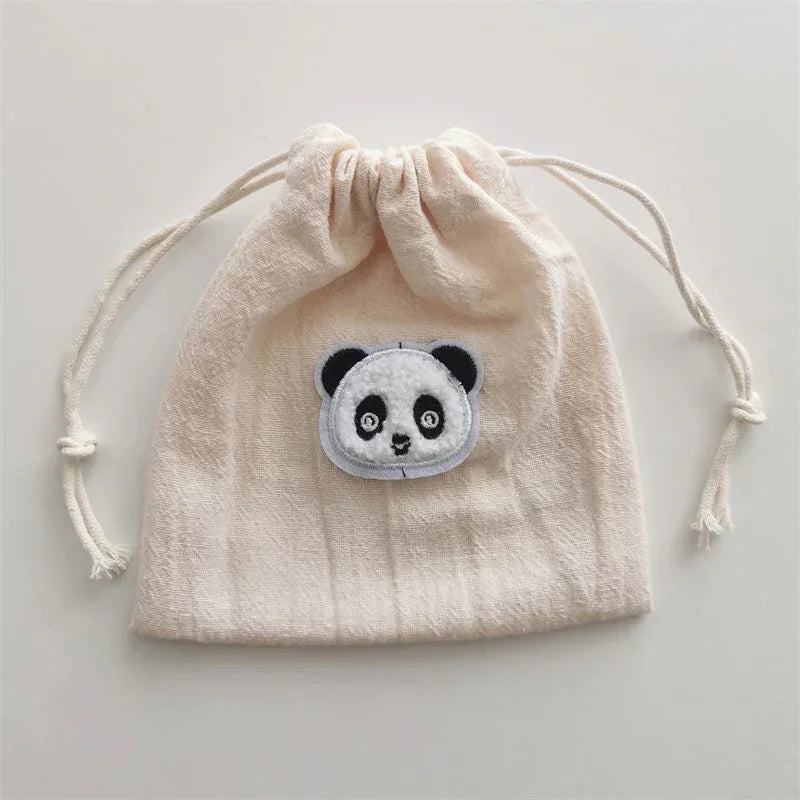 Beige cotton drawstring pouch with panda face embroidery, soft fabric, casual style