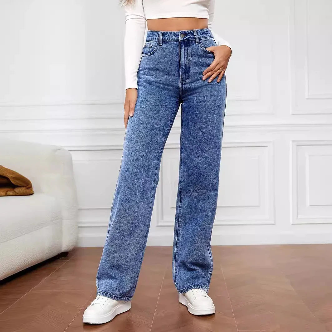 Woman wearing high-waisted blue wide-leg jeans with a relaxed fit and white crop top.