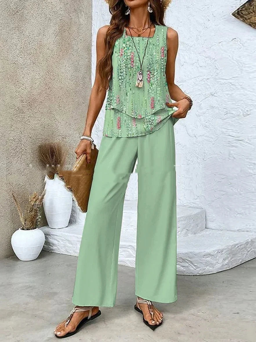 Woman wearing sleeveless mint green floral top and wide-leg pants, relaxed summer outfit