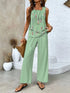 Woman wearing sleeveless mint green floral top and wide-leg pants, relaxed summer outfit