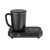 Matte black ceramic mug with lid on a sleek electric mug warmer and wireless charger