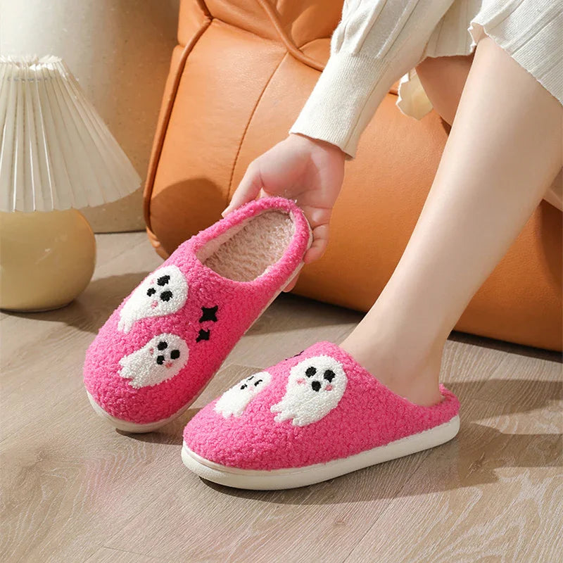 Pink fuzzy slippers with cute white ghost designs, cozy indoor footwear, relaxed fit