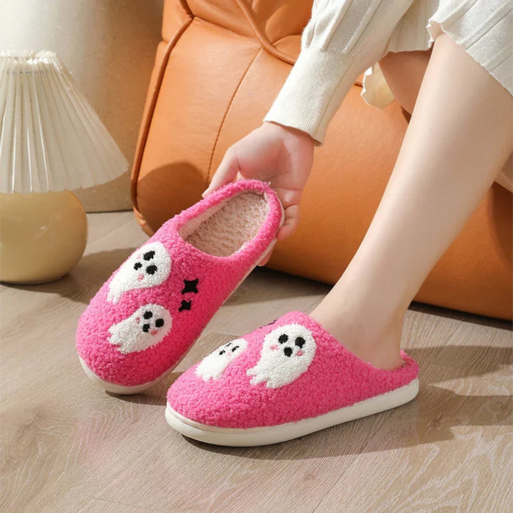 Pink fuzzy slippers with cute white ghost designs, cozy indoor footwear, relaxed fit