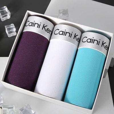 Boxed set of men's cotton trunks in purple, white, and light blue with modern fit